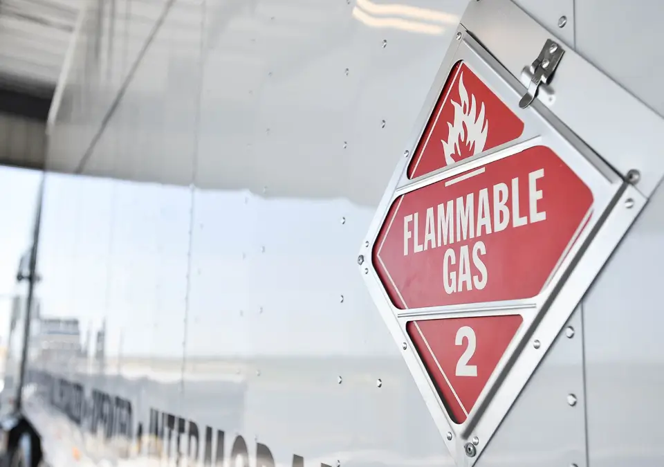 A flammable gas sign displayed on the side of a truck.